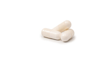 White pill capsule isolated on a white background.