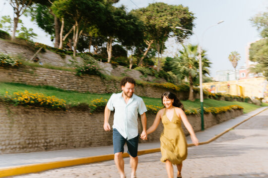 Dinamic Couple Running On Park Path