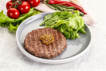 Frilled beef burger cutlet with iceberg