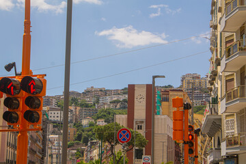 traffic light on the street in the city of Naples and colourful Italian buildings on the...