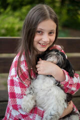 Teenage Girl with a Shih Tzu Dog. 10-Year-Old Girl with a Black and White Shih Tzu
