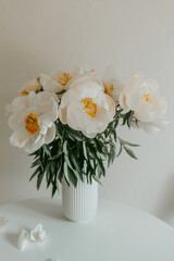 Still life with white peonies on white background 