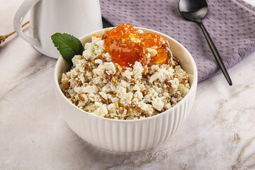 Curd with granola and orange jam