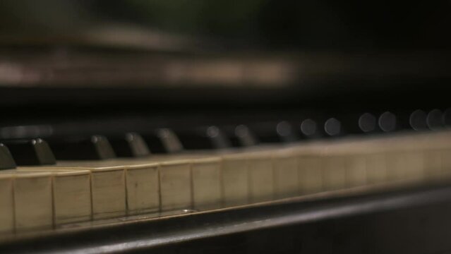 Music lesson, art education or homework. Cinematic keys old vintage piano, close up, music background, skill