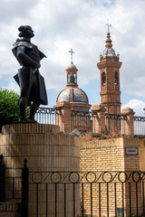 A statue of a bullfighter stands next to the Triana Bridge, located in the famous Triana...