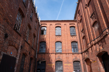 The characteristic red brick industrial buildings of the former textile factories in Żyrardów, Poland, stand as enduring symbols of the town's rich industrial heritage.
