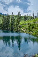 italian alps dolomites national park lake mountain trekking peaks tre cime brais lake carezza lake reflection clouds