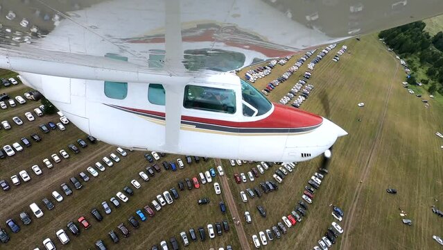 Wing view of a small four-seater airplane during flight. 