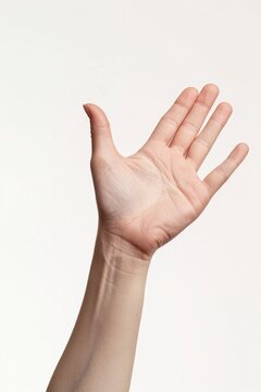 A person holds their hand up in the air, palms facing upwards, suggesting surrender or defeat