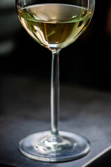 Close-Up of a White Wine Glass Against Dark Background