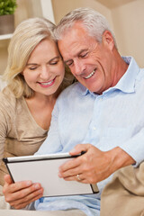 Happy Senior Man and Woman Couple Using Tablet Computer at Home