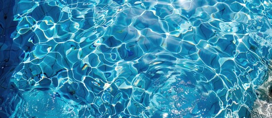 Obraz premium Abstract overhead view of empty swimming pool with crystal clear water surface and blue underwater pattern, devoid of any swimmers.