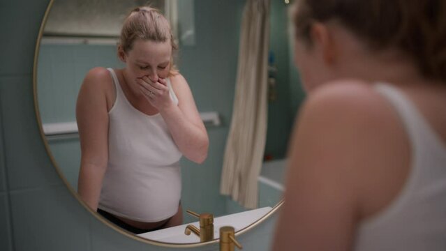 Nauseous Pregnant Lady In Front Of The Bathroom Mirror