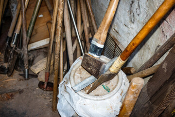 Gardening tools stored in a rustic shed