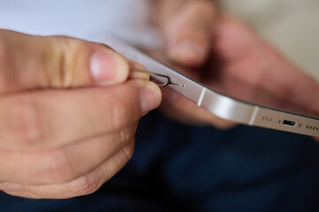 Guide on how to properly insert a SIM card into a smartphone using a SIM removal tool