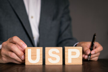 There is wood cube with the word USP. It is an abbreviation for Unique Selling Proposition as eye-catching image.