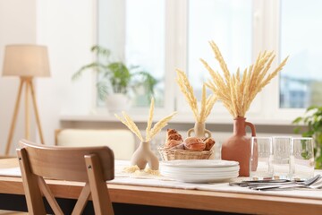 Clean dishes, dry spikes and fresh pastries on table in stylish dining room