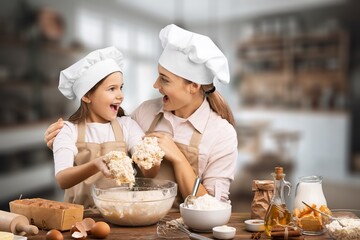 Joyful Mother And Daughter Cooking At Modern Kitchen