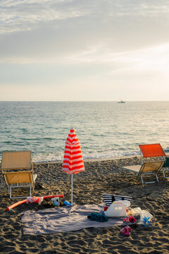 Beach with blue umbrellas on Mediterranean coast 