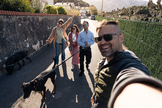 Friends Enjoying a Walk With Dog on Sunny Day