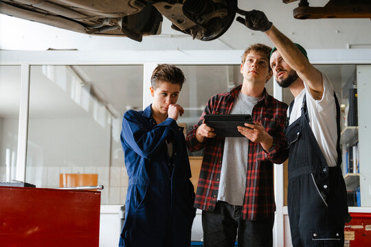 A group of people working in an auto repair shop