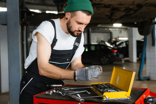 A man takes a tool out of a suitcase
