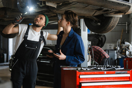 A group of people working in an auto repair shop