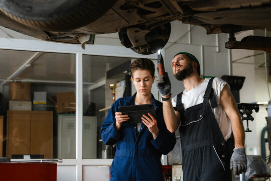 A group of people working in an auto repair shop