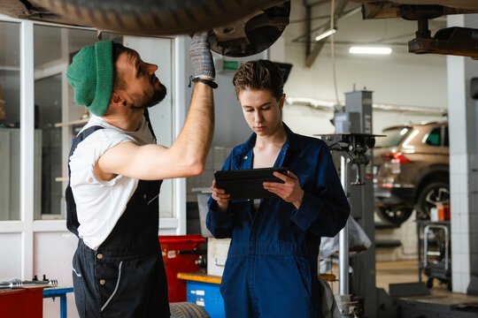 A group of people working in an auto repair shop