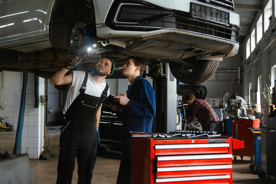 A group of people working in an auto repair shop