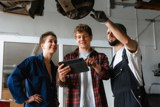 A group of people working in an auto repair shop