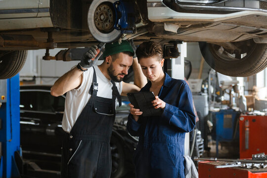 A group of people working in an auto repair shop