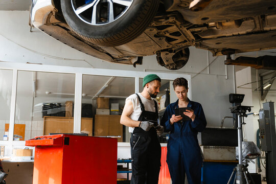 A group of people working in an auto repair shop