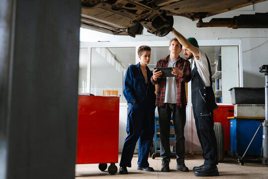 A group of people working in an auto repair shop