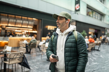 man with headphones in shopping center