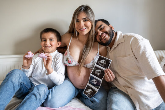Happy family with baby ultrasound.