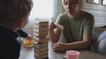 Mother and Son Play Jenga Board Game at Home