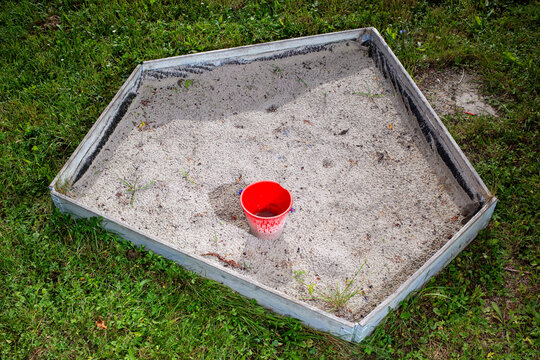 Small sandpit with a bucket
