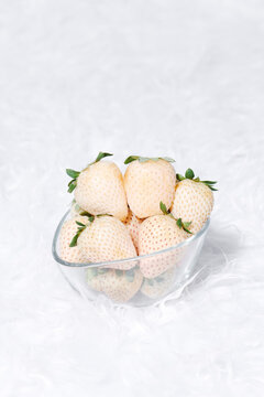 glass bowl with some white strawberries