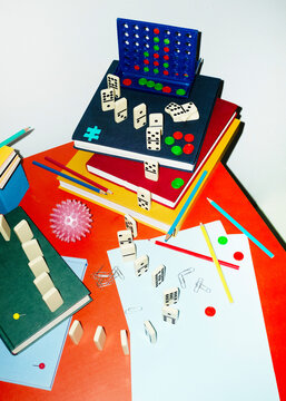 Curvy playful tactic row of dominos in office desk and hard flashlight