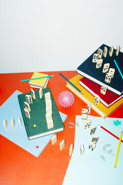 Curvy playful tactic row of dominos in office desk and hard flashlight