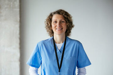Smiling woman in medical uniform at hospital