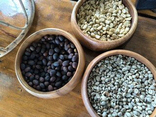 Various coffee beans in a wooden bowl