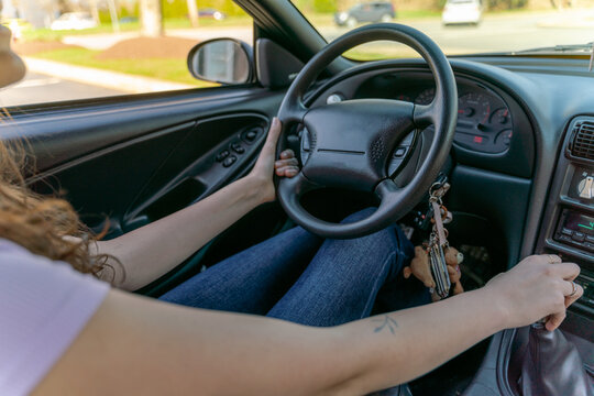 anonymous young woman driving her car  