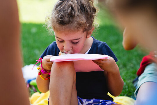 Girl eating a slice of cake