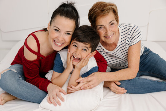 Multigenerational family enjoying time together on a bed
