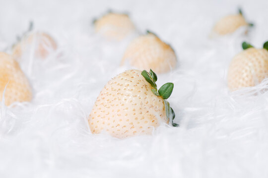 white strawberries on a white fabric