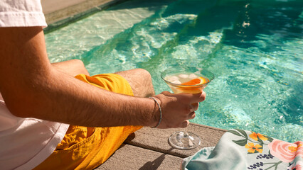 Man with a Drink by the pool