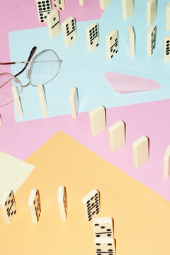 Curvy playful tactic row of dominos in office desk and hard flashlight