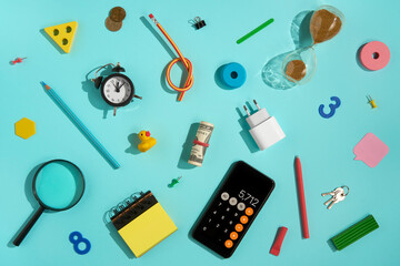 Flat lay of office and business supplies on blue background